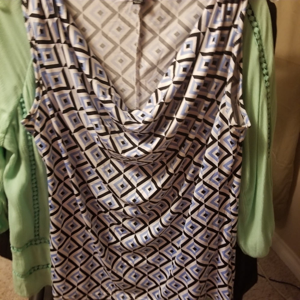 Sleeveless blue, black and white shirt.